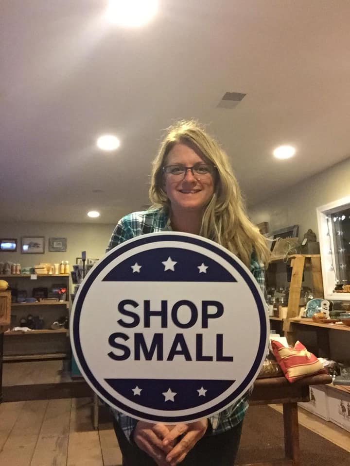 woman holding Shop Small signage