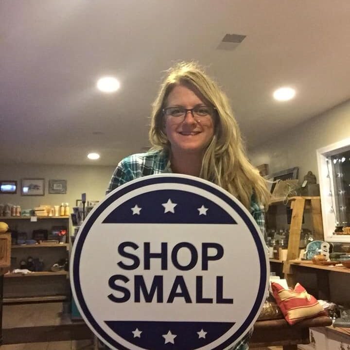 woman holding Shop Small signage